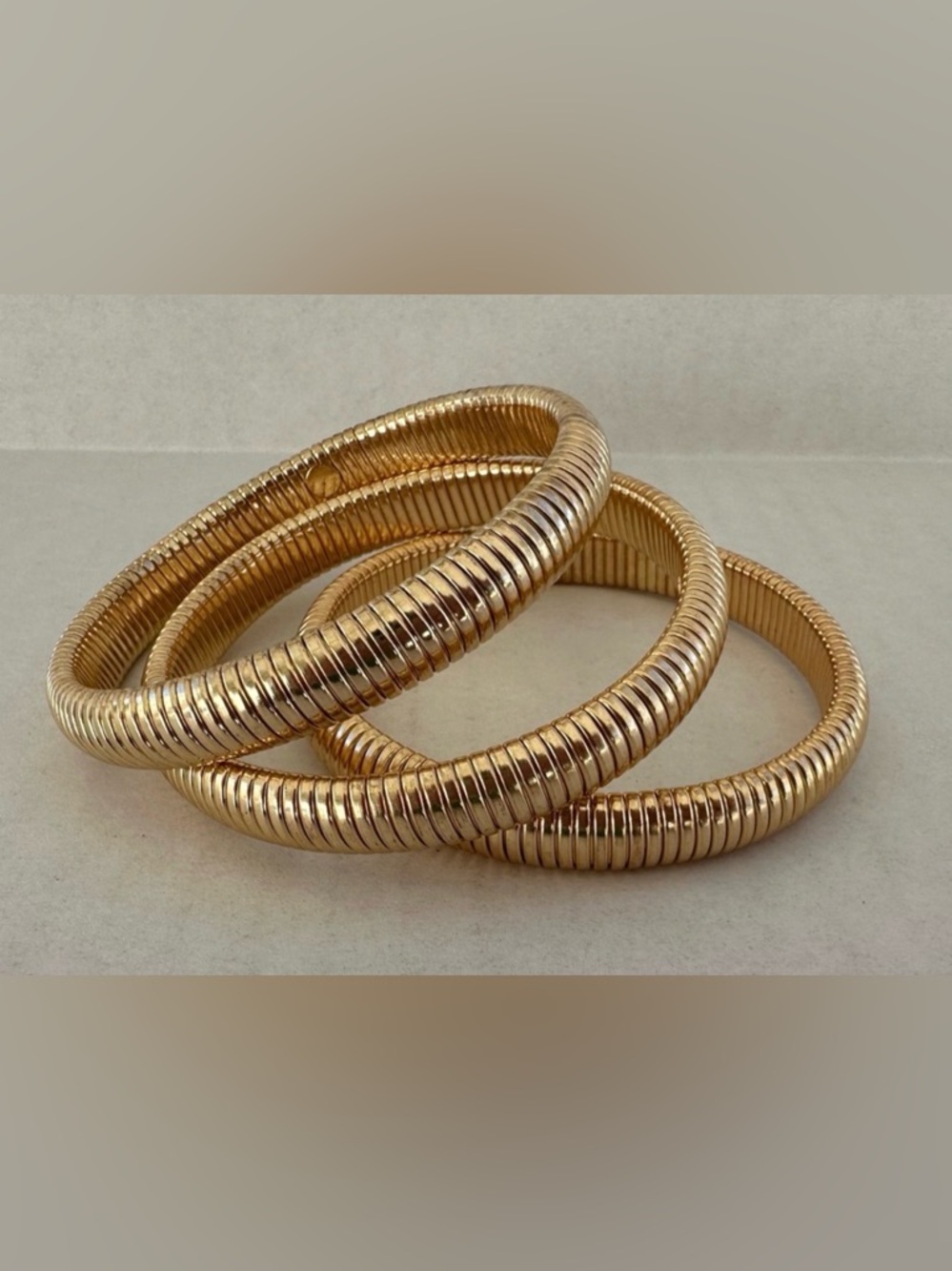 3 Gold-tone stretch “Snake Chain” bangles